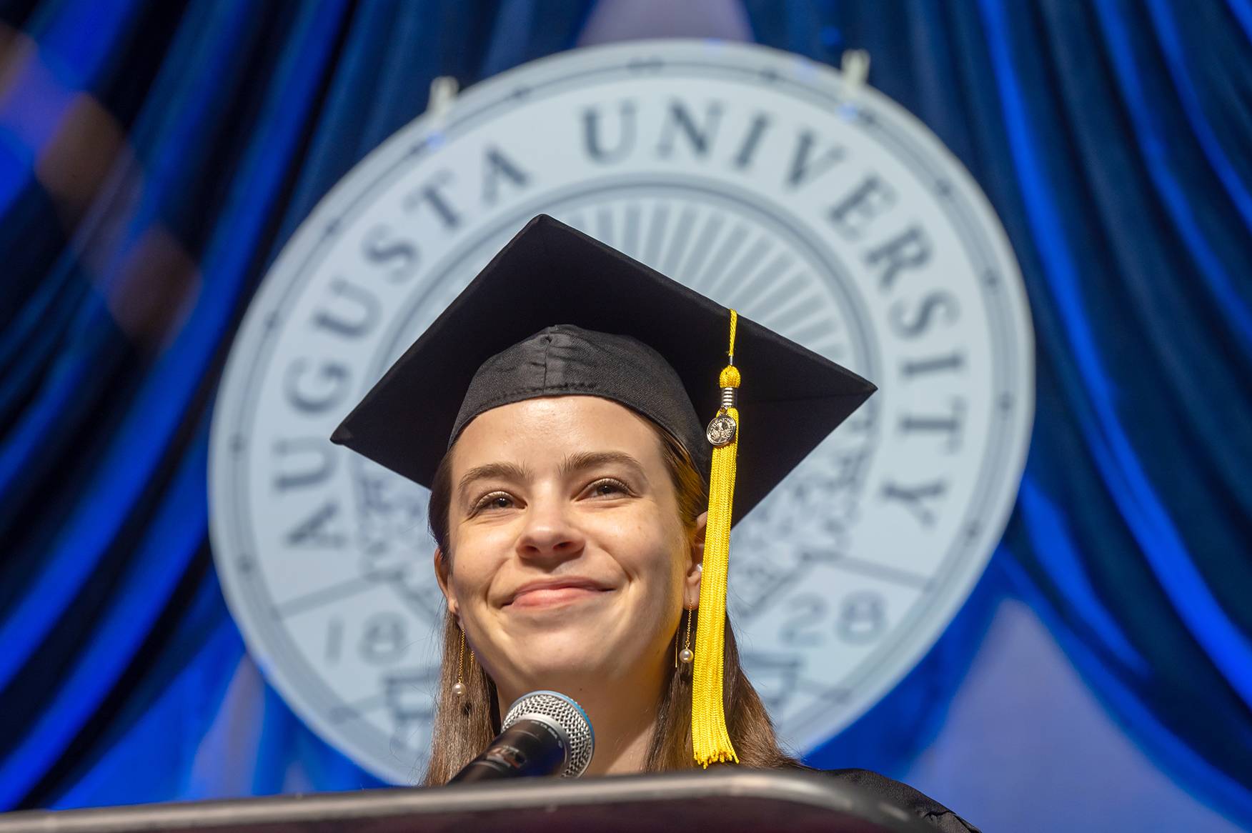 woman smiling at podium