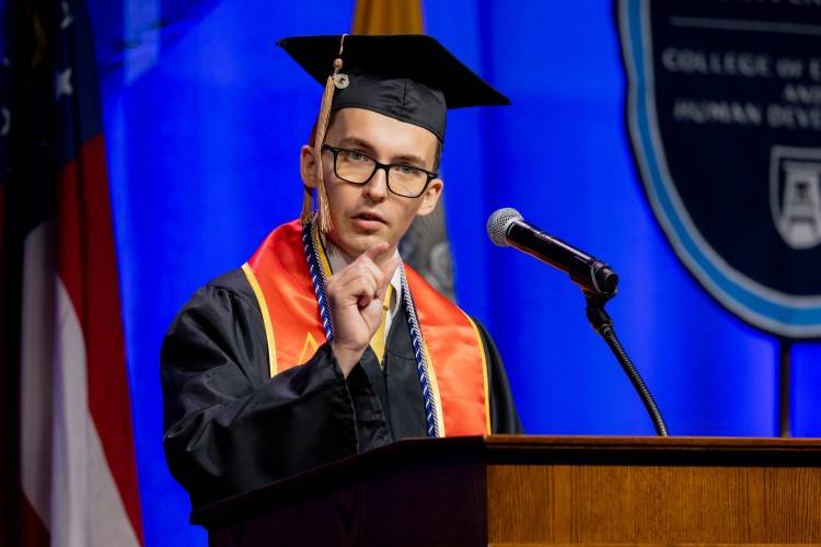 man speaking at podium