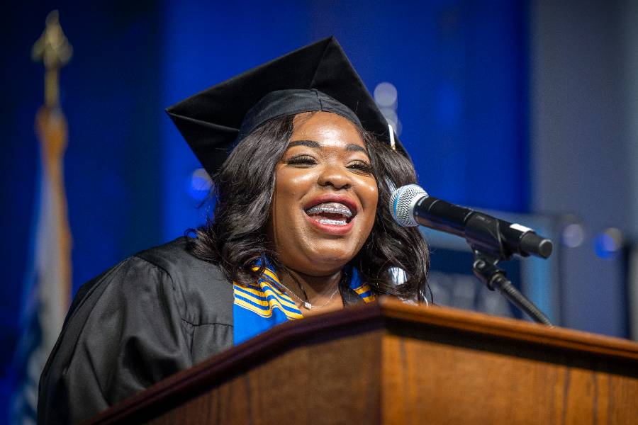 female graduate speaking at podium