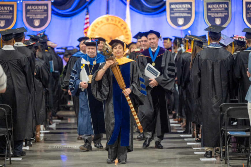 Faculty members leaving convention center after commencement