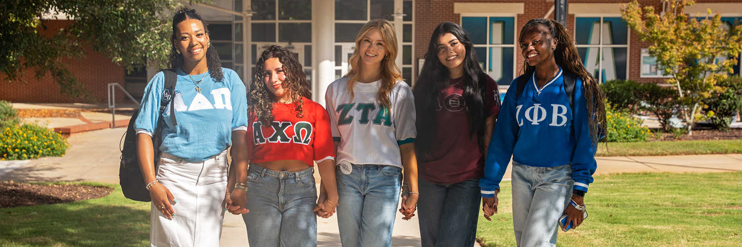 Members from different sororities posing on campus