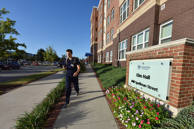 Student walking outside of resident building