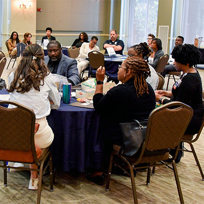 C.E.L. members at tables during the meeting