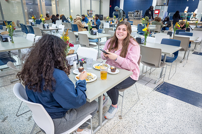 Students eating food in the atrium dining hall