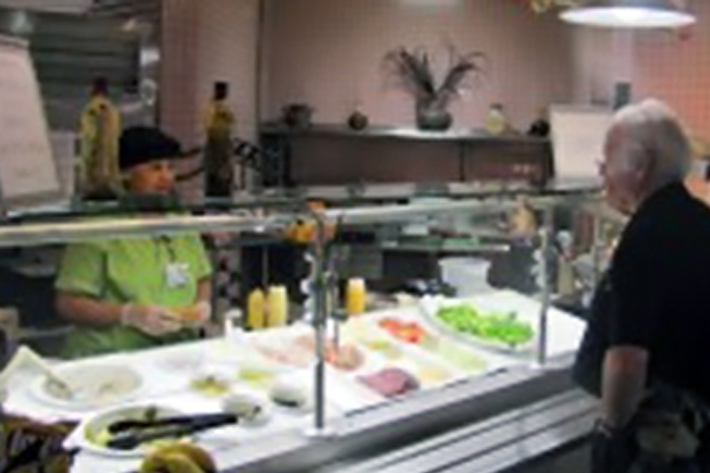 Customer standing in front of the food bar in Terrace Dining