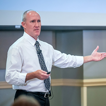 Faculty member giving a lecture using technology