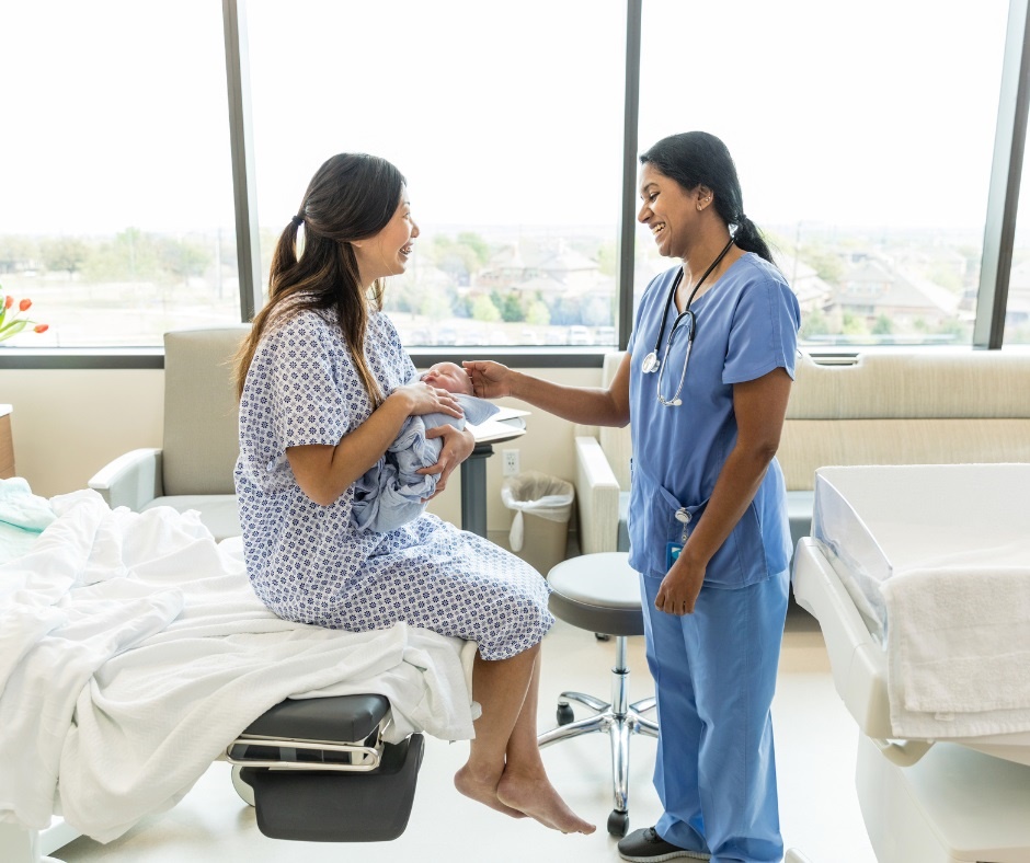 Woman with baby talking to nurse