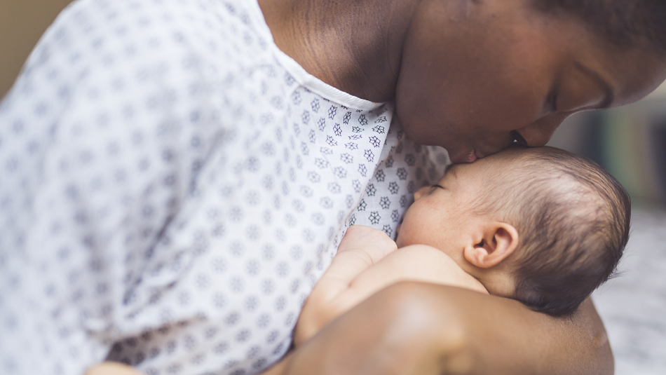 Mother kissing her newborn