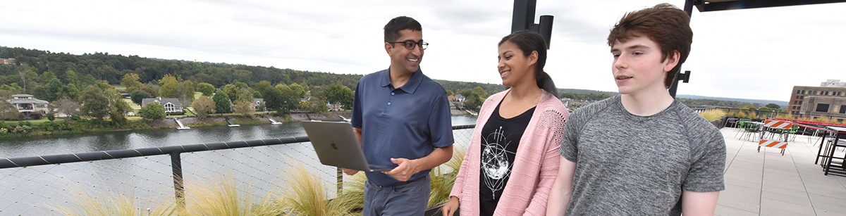 Students on laptop outside