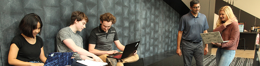 Students with laptops at cyber center