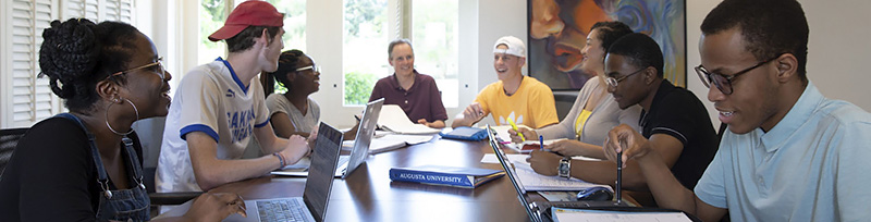 Students gathered around a table studying