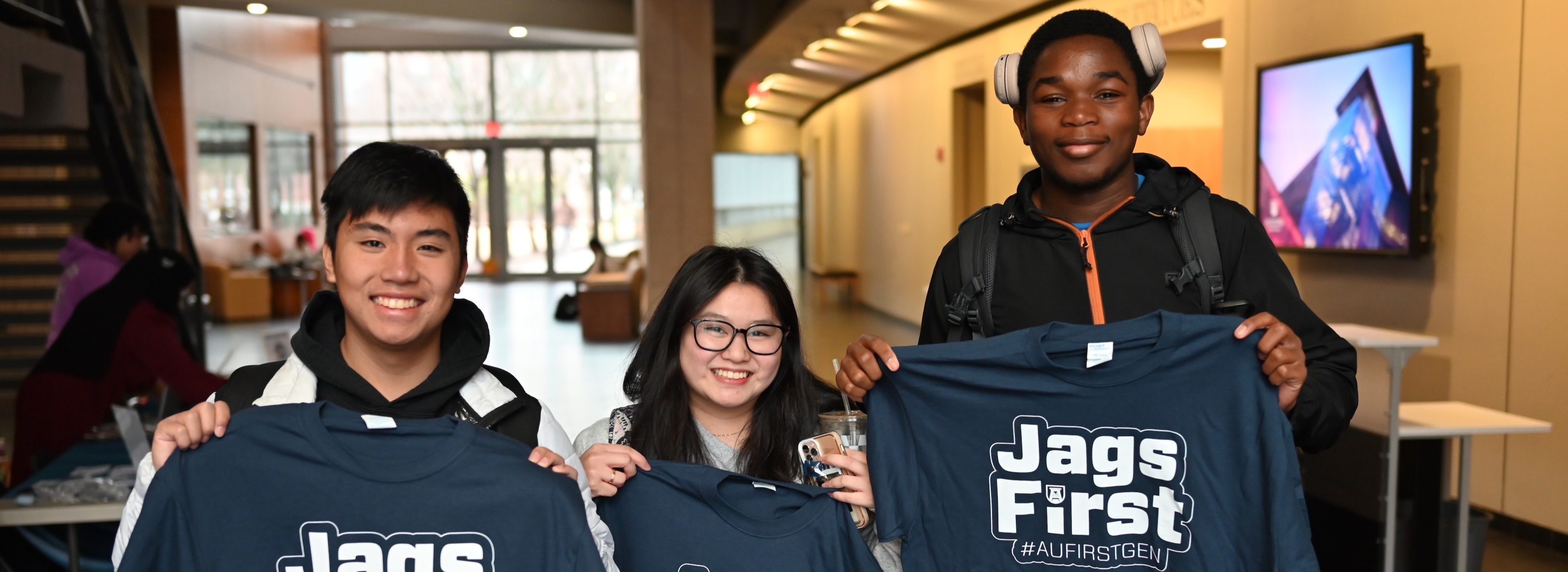students holding up #JagsFirst t-shirts