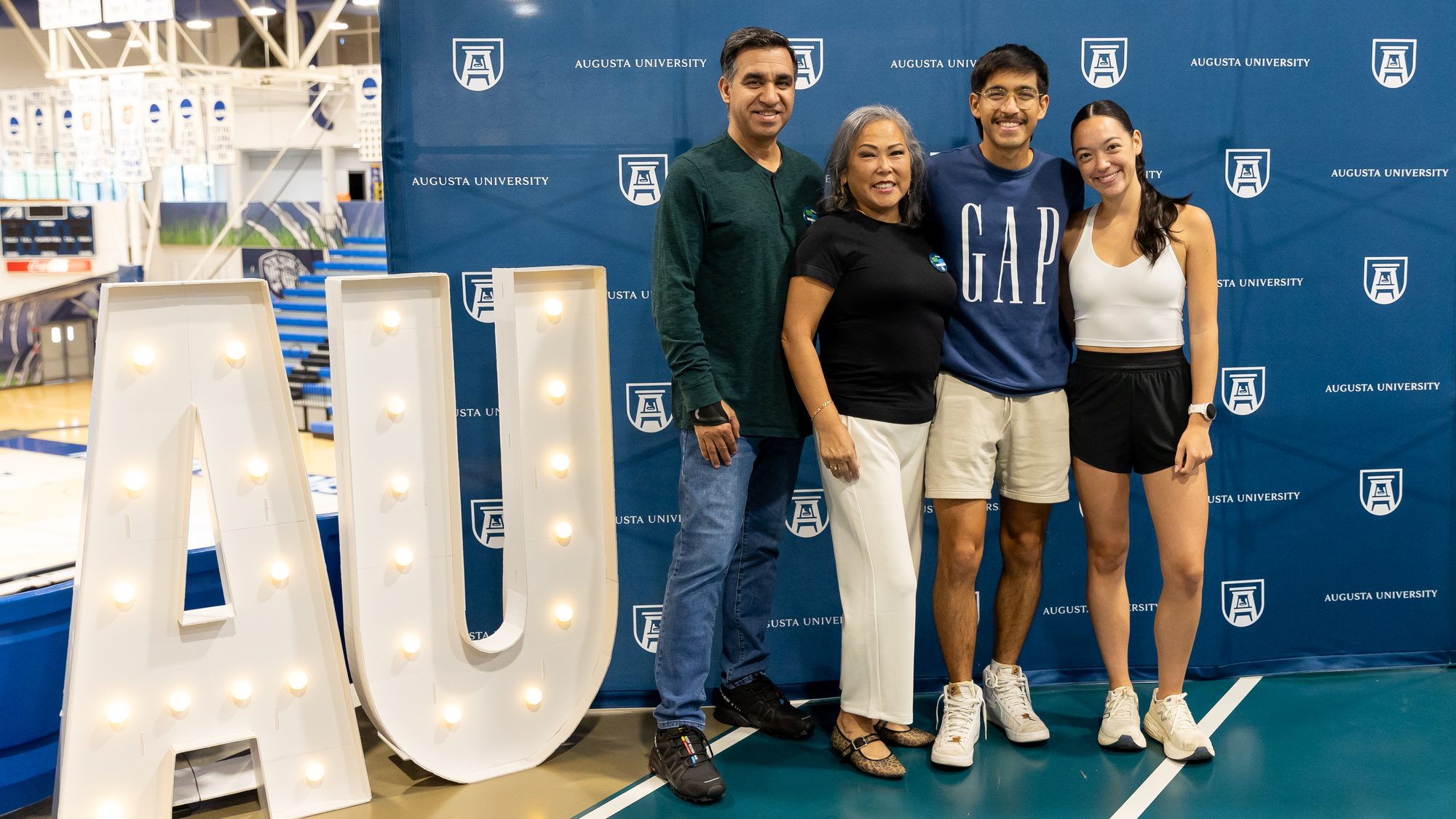Family members smile together at an Augusta University event.