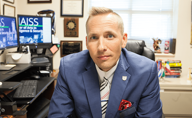 Man looks at the camera in an office.