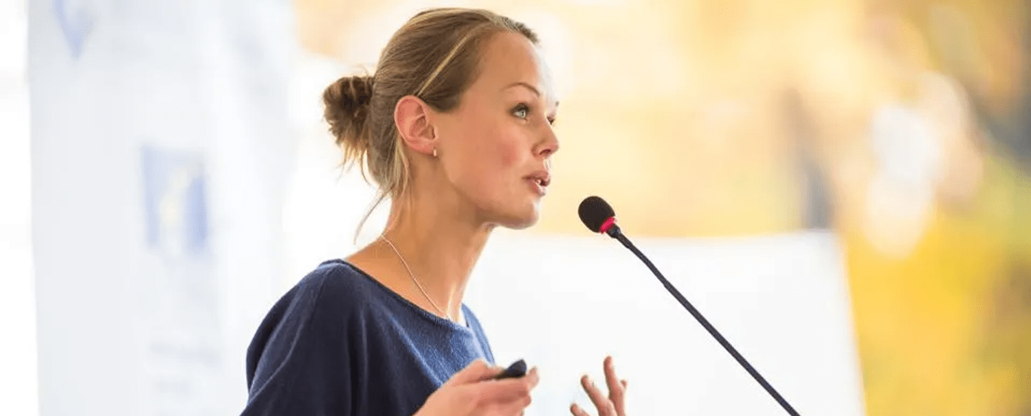 Woman leads a presentation at a conference.