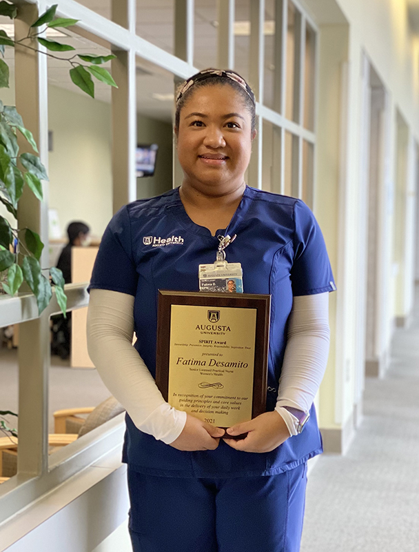 Fatima Desamito holding her spirit award