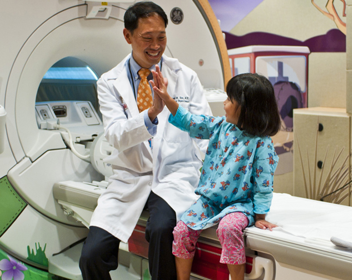 Doctor sitting with Child before undergoing procedure