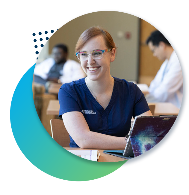 Student in scrubs smiles in classroom