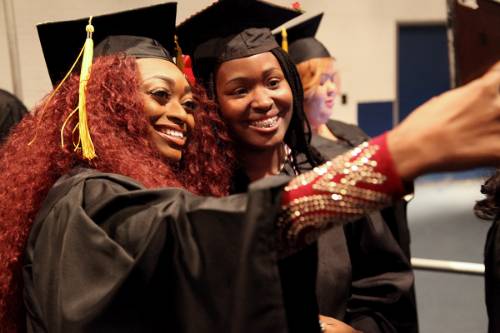 Students taking a selfie just before graduation