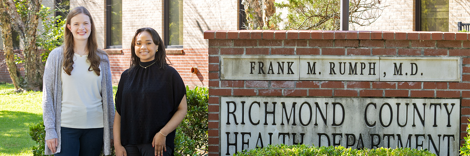 Female student interns standing outside the Richmond County Health Department