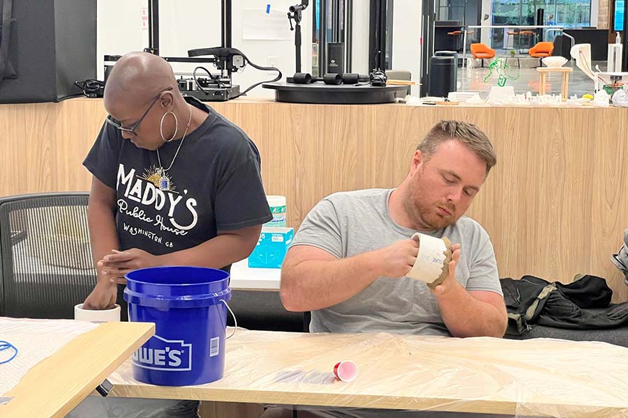 two people working on clay art