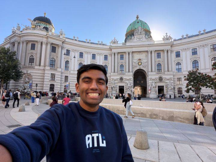 man stands in front of building