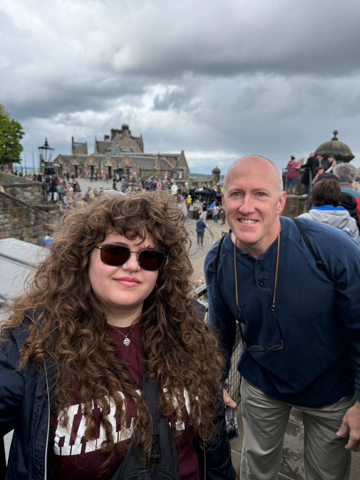 women and man pose in front of historic building