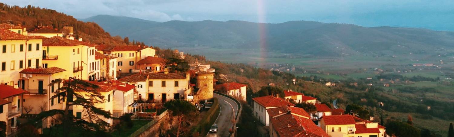 Italian village with a rainbow at sunset