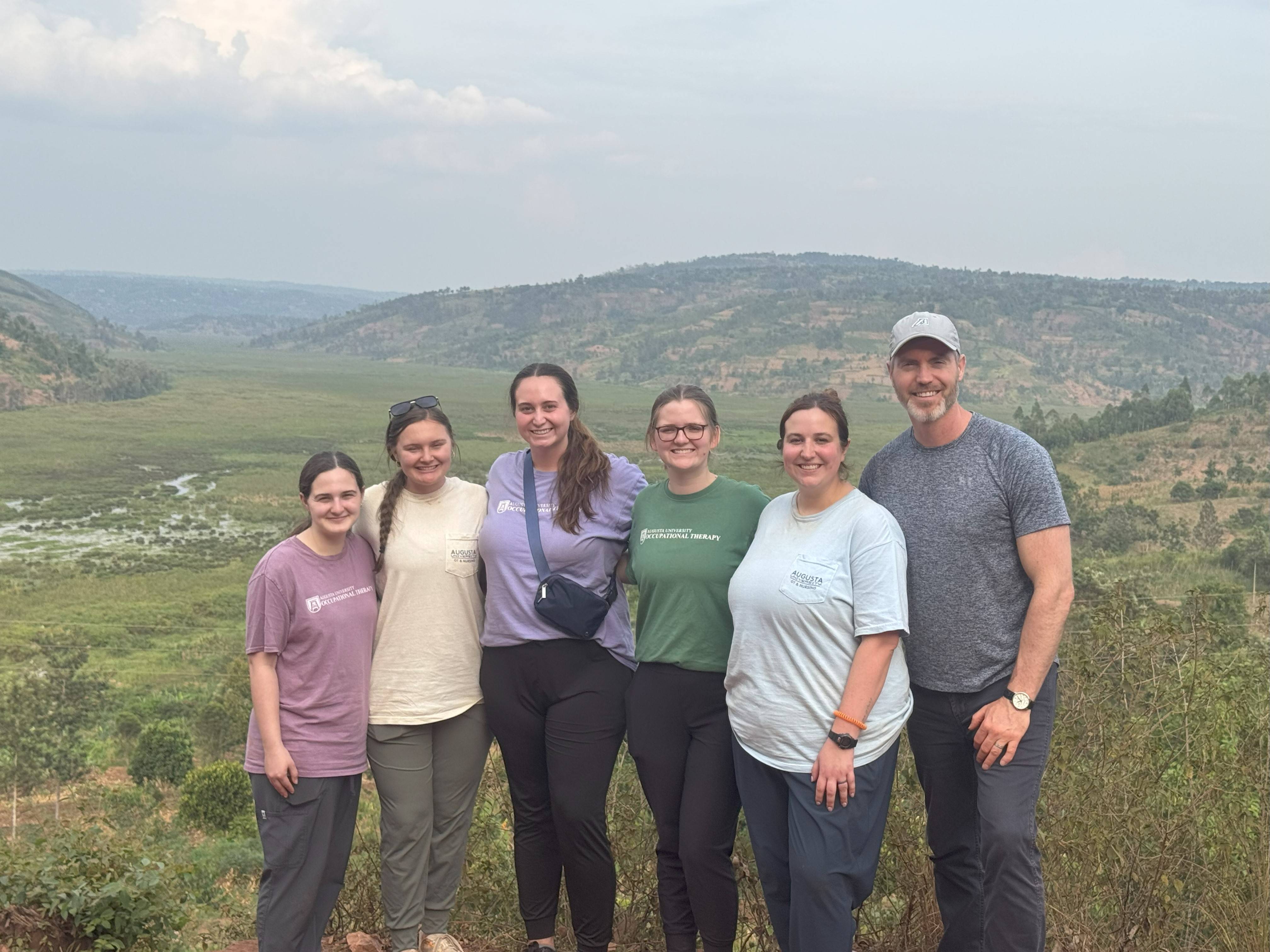 students posing in front of a mountain backdrop