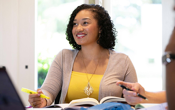 Student looking hopefully ahead in her class