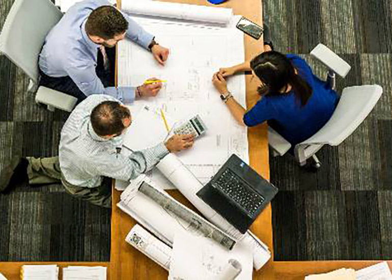 business professionals surrounding a table