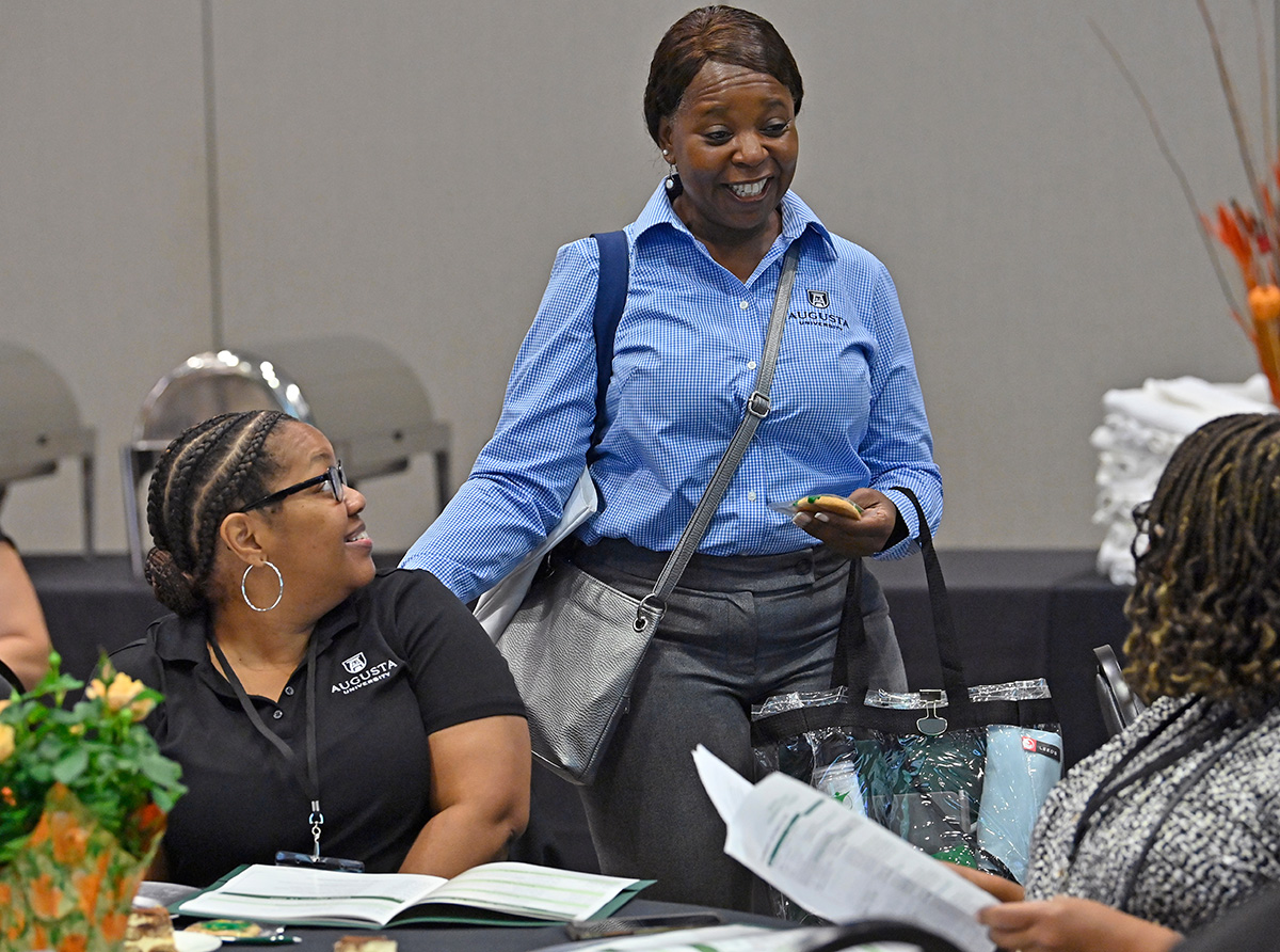 Staff Council Conference attendees speaking to each other